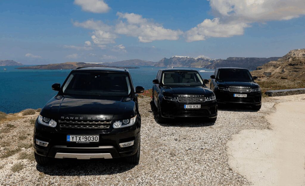 range rover vehicles over cliffside landscape in santorini, part of the My Santorini Transfer fleet