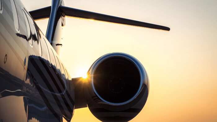 Close-up of private jet engine at Santorini Airport during sunrise, symbolizing luxury travel and private transfer arrivals.