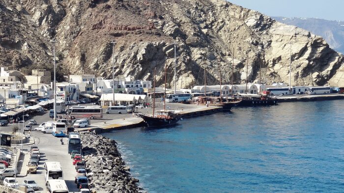 Cruise ship arriving at the Santorini caldera, a common entry point for visitors requiring port transfers.