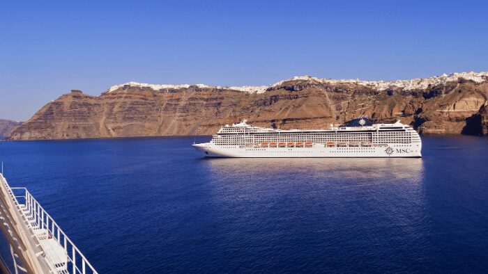 MSC cruise ship departing from Santorini, highlighting the importance of timely port-to-ship transfers.