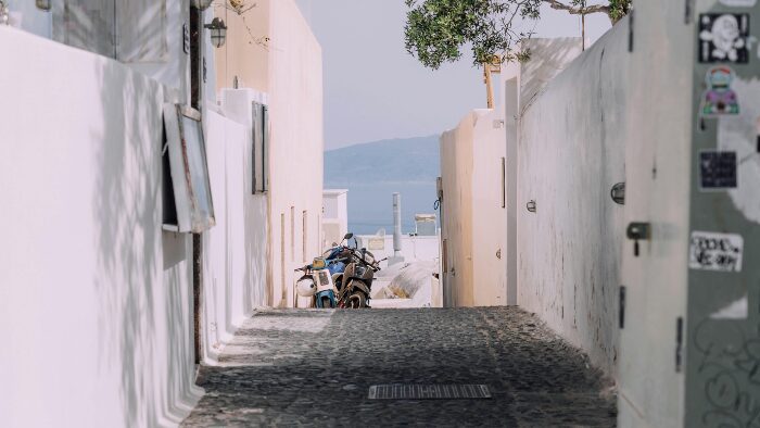 Quiet cobblestone street in a traditional Santorini village, ideal for relaxed walking