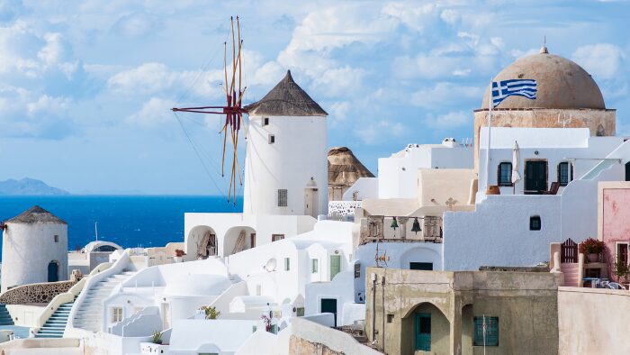 Panoramic view of Oia village perched above the caldera in Santorini