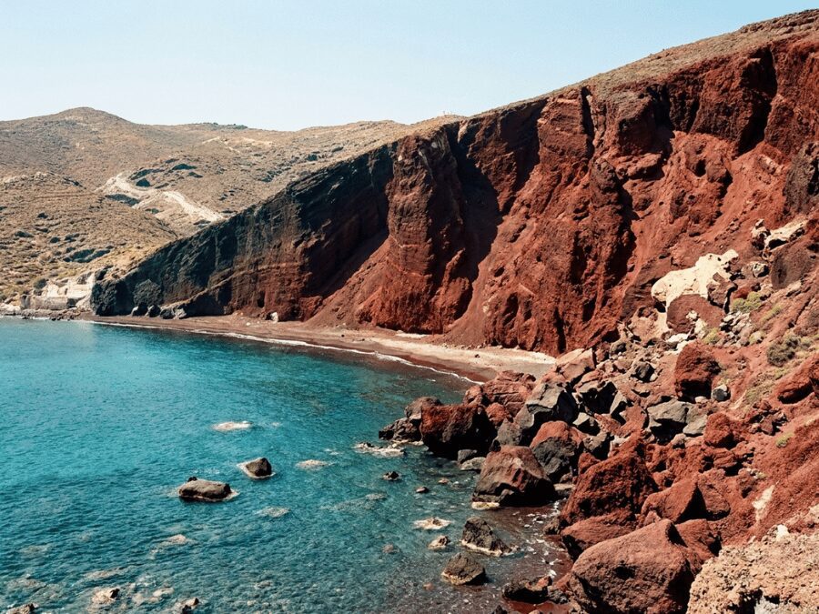 Red Beach with iron-red volcanic cliffs and turquoise Aegean