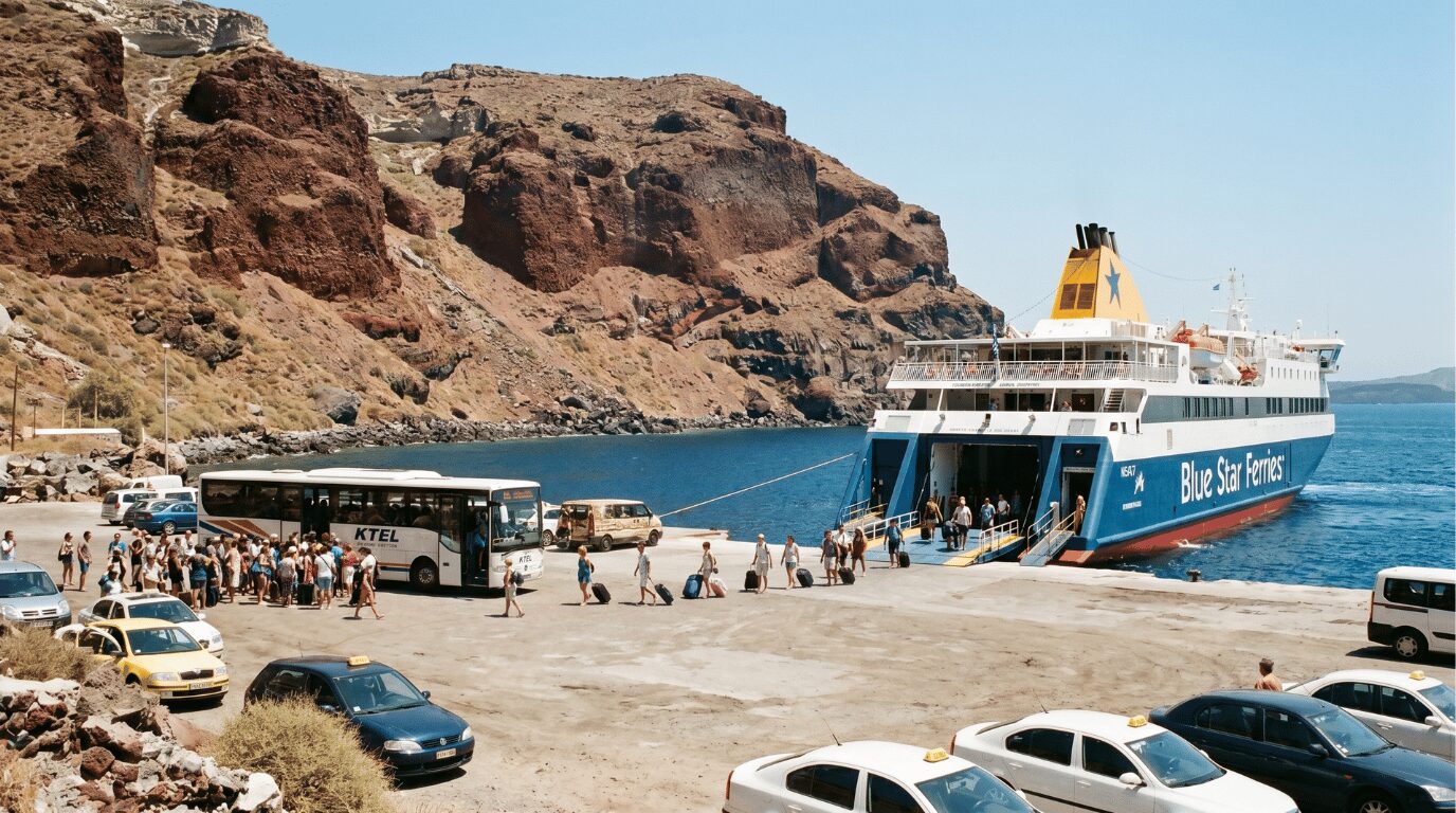Travelers and a waiting bus at Athinios ferry port below Santorini's caldera cliffs