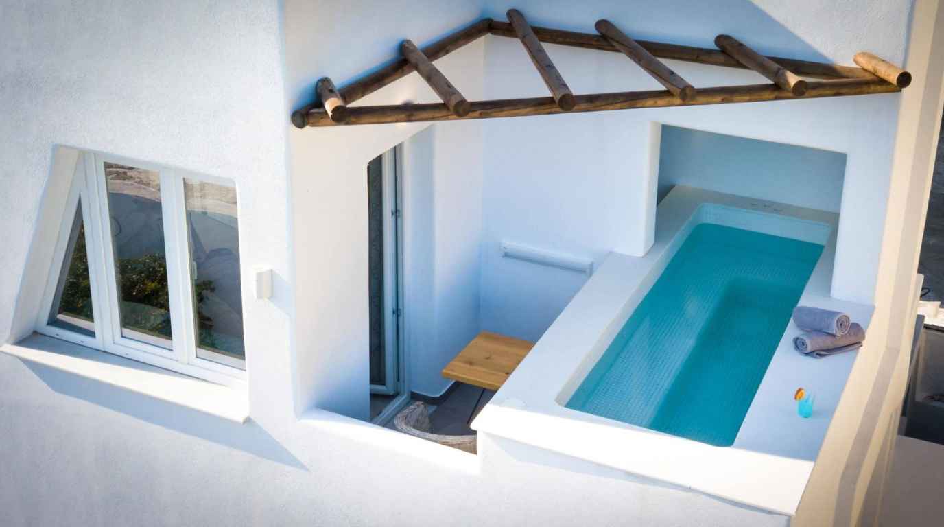 Boutique suite terrace with a private outdoor hot tub in a quiet Santorini village