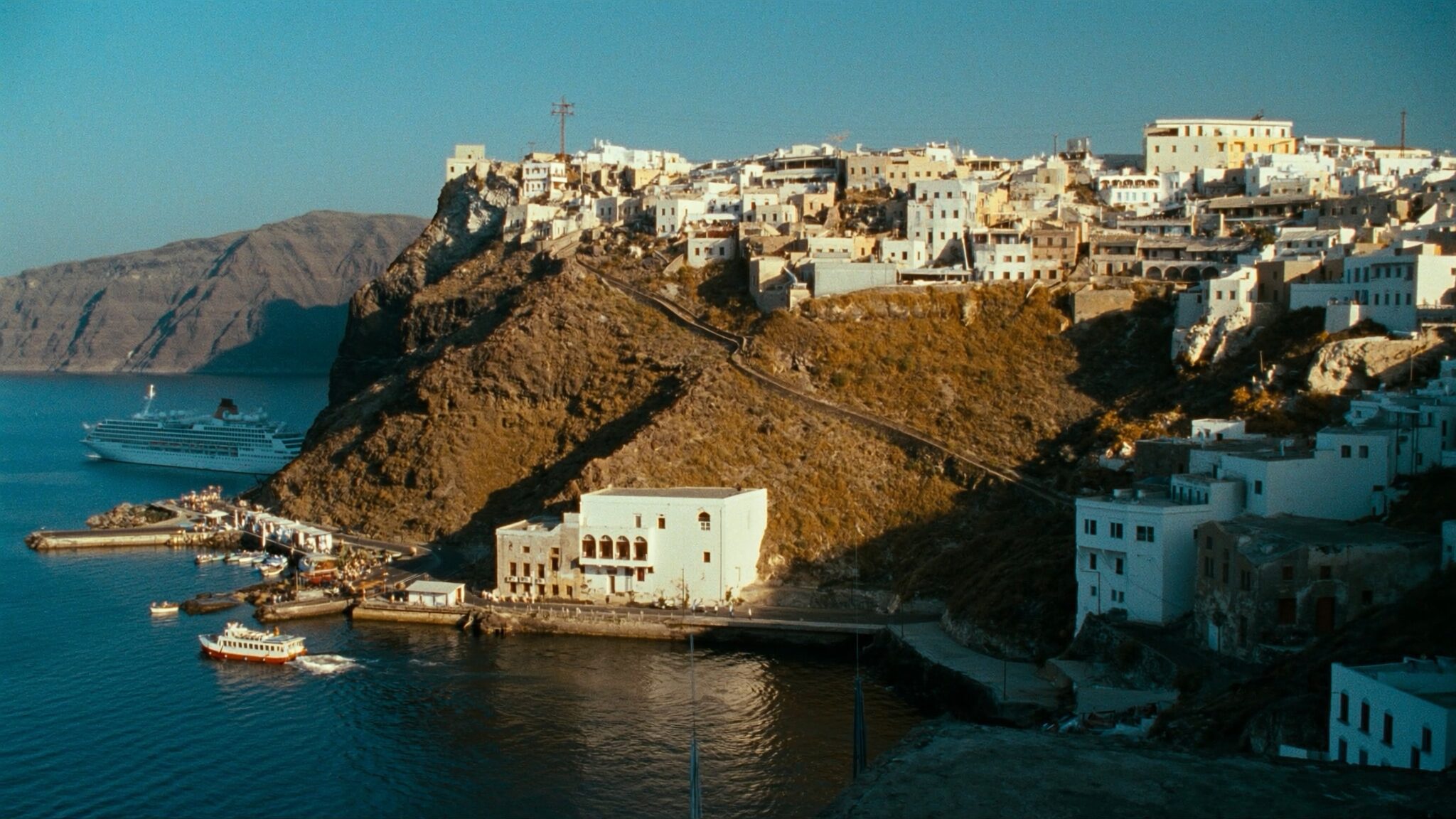 Cruise ship tenders at Santorini Old Port Skala with the cable car climbing to Fira